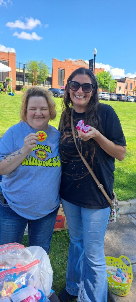 Angie and Codi holding crocheted items